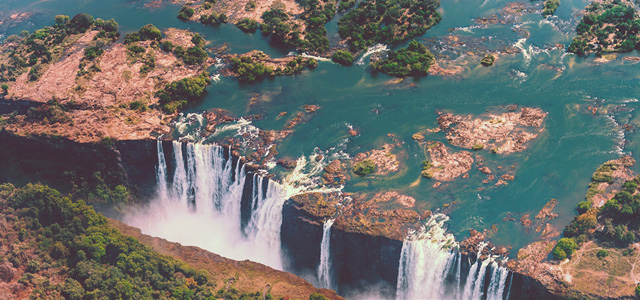 Aerial view of Victoria Falls and the surrounding Zambezi River landscape in Zambia, illustrating the About Hollard Zambia page.